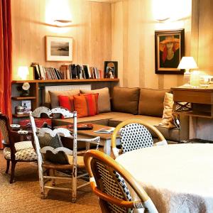 a living room with a couch and chairs and a table at Logis Saint-Flaceau in Le Mans