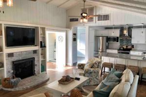 a living room with a couch and a fireplace at One-of-a-kindBeach, Village, Dock & Private Pool! in Siesta Key