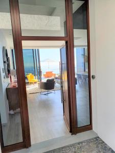a glass door leading into a living room at Villa Brava Atlântico in Ribeira Brava