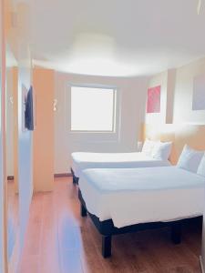 Cama ou camas em um quarto em Ibis Cancun Centro