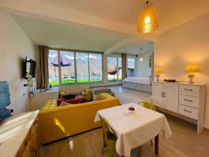 a living room with a yellow couch and a table at DUBAI by luxury Atitlan in San Pedro La Laguna