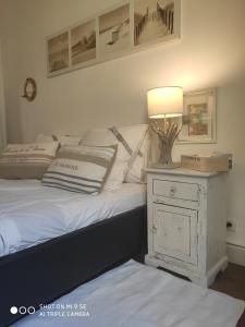 a bedroom with a bed with a lamp on a night stand at Chambre au panier in Marseille