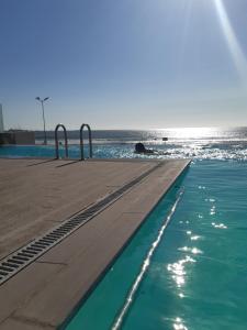 a swimming pool with the ocean in the background at Pacifico 802 in Arica