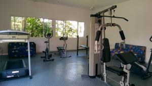 a gym with tread machines and a bed in a room at Ecotel Quinta Regia in Valladolid