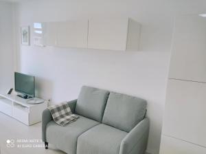 a living room with a couch and a television at Los Cristianos to enjoy, relax and live the ocean! in Los Cristianos