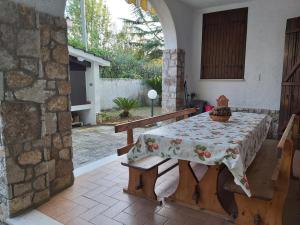 a table with a table cloth on it in a patio at Villa l'Amante in Fondi