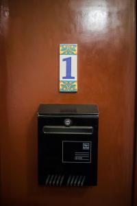 a mail box with a letter l sign on a wall at Home in Krakow Silvio's Apartments in Krakow