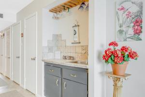 a kitchen with a sink and a vase of red flowers at Sea Colony Edgewater House IV in Bethany Beach +25 photos