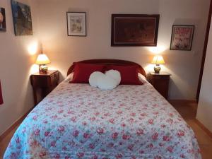 a bedroom with a bed with a stuffed animal on it at La PASTORALE in La Puisaye