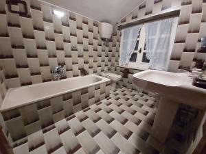 a bathroom with a tub and a sink and a bath tub at Villa l'Amante in Fondi