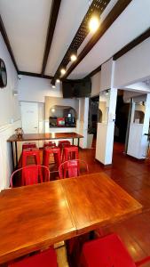 une salle de conférence avec des tables en bois et des chaises rouges dans l'établissement Hotel Positano, à Mar del Plata