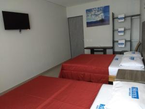 Ліжко або ліжка в номері Hotel Guivá San Pablo