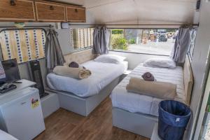 a bedroom with two beds and a tv in it at Leithfield Beach Holiday Park in Leithfield