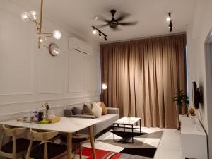 a living room with a couch and a table at TROIKA DREAM HOME in Kota Bharu