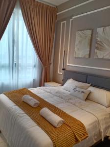 a bedroom with a large bed with two pillows on it at TROIKA DREAM HOME in Kota Bharu