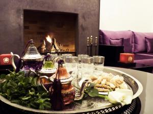 a tray of food on a table with a fireplace at Ryad Amiran & Spa in Marrakesh