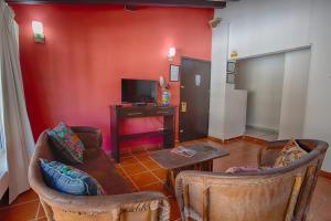 a living room with two chairs and a television at La Iguana Vallarta LGBT ADULTS ONLY - Romantic Zone - Party Clubbing Street in Puerto Vallarta