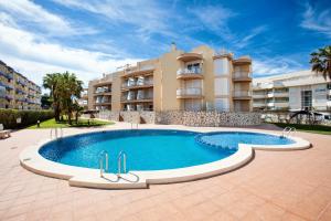 a swimming pool in front of a building at Zurich 47 by homeprive in Denia
