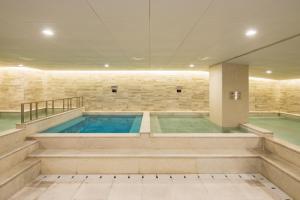 a large swimming pool in a building at Orakai Cheonggyesan Hotel in Seoul