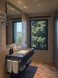 a bathroom with a large sink and a large window at Rastrello in Panicale