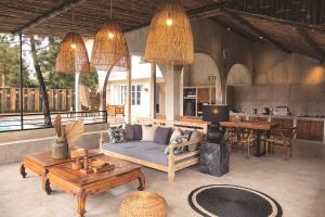 a living room with a couch and a table at Villa Stella By The Villas 100 in Bogor