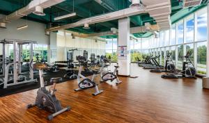a gym with treadmills and elliptical machines at Eastin Hotel Penang in Bayan Lepas