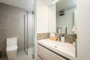 a bathroom with a toilet and a sink and a shower at The Nest Central Christchurch in Christchurch