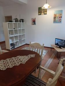 a living room with a wooden table and chairs at Piccola Italia Casa Racovita in Cluj-Napoca