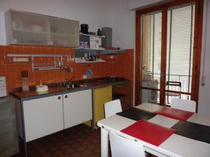 a kitchen with a sink and a table with chairs at A Firenze da Paolo in Florence