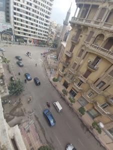 a city street filled with lots of cars and buildings at Victory Of Downtown Hotel in Cairo