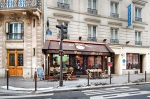 un edificio en la esquina de una calle con una tienda en Hôtel De Paris Opera, en París