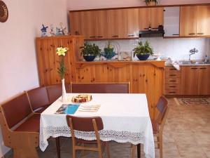 a kitchen with a table with a white table cloth at Comfortable holiday home in Labin in Drenje