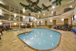 a large pool in the middle of a large building at Motel 6 Minot, ND in Minot