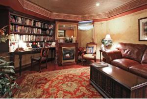 a living room with a leather couch and a desk at Old Northside Bed & Breakfast in Indianapolis