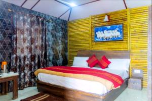 a bedroom with a large bed with red pillows at Glamwood Resort Dhanaulti, Ranked 1 in Dhanaulti in Dhanaulti