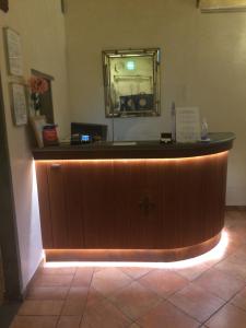 a reception desk with a mirror on the wall at Hotel Renaissance in Florence