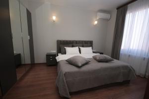 a bedroom with a bed with two pillows on it at Hillside Guest House in Yerevan