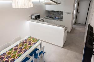 a small kitchen with a counter top and a counter top at Marina in Brolo