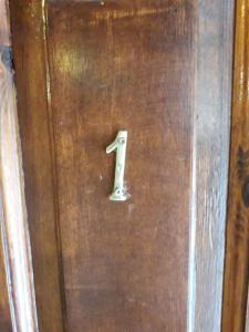 a wooden door with a number one on it at Mystic Lake in Koukouli