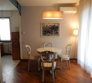 a dining room with a table and chairs at Trilocale Ferruccio in Baveno +13 photos