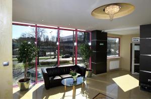 a living room with a couch and a glass table at Hotel & Restauracja Glass in Radom