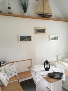a room with a bed and a table and chairs at Ferienhaus Alte Schule Rambin auf Rügen in Rambin
