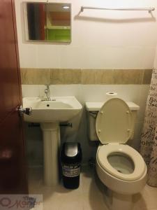 a bathroom with a toilet and a sink at The Manor Hotel in Davao City +39 photos