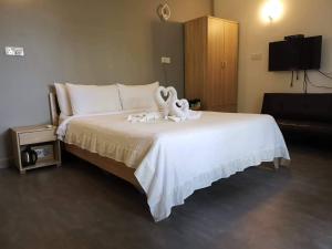 Postel nebo postele na pokoji v ubytování Dravida Hotel