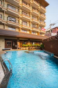 a swimming pool in front of a hotel at Sunview Place in Pattaya Central