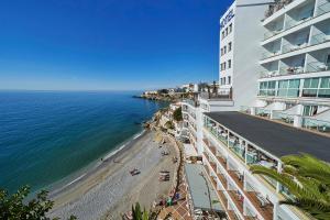 a view of the beach and the ocean from a building at Hotel Balcón de Europa in Nerja