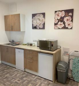 a kitchen with a microwave on top of a counter at Private 1st Floor Apartment - Perfect for Port of Dover, Eurotunnel and Short Stays in Dover