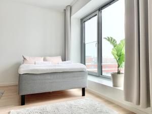 a bedroom with a bed and a large window at City Home Finland Big Luxury Suite - Spacious Suite with Own SAUNA, One Bedroom and Furnished Balcony next to Train Station in Tampere