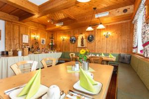 a dining room with wooden walls and wooden tables at Hotel-Pension Lackenbauer in Bad Hofgastein