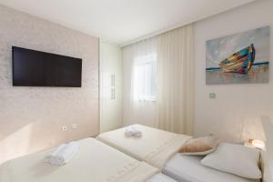 Giường trong phòng chung tại Tarari Luxury Apartment